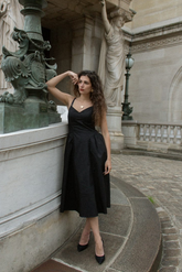 a lady in a black slip dress